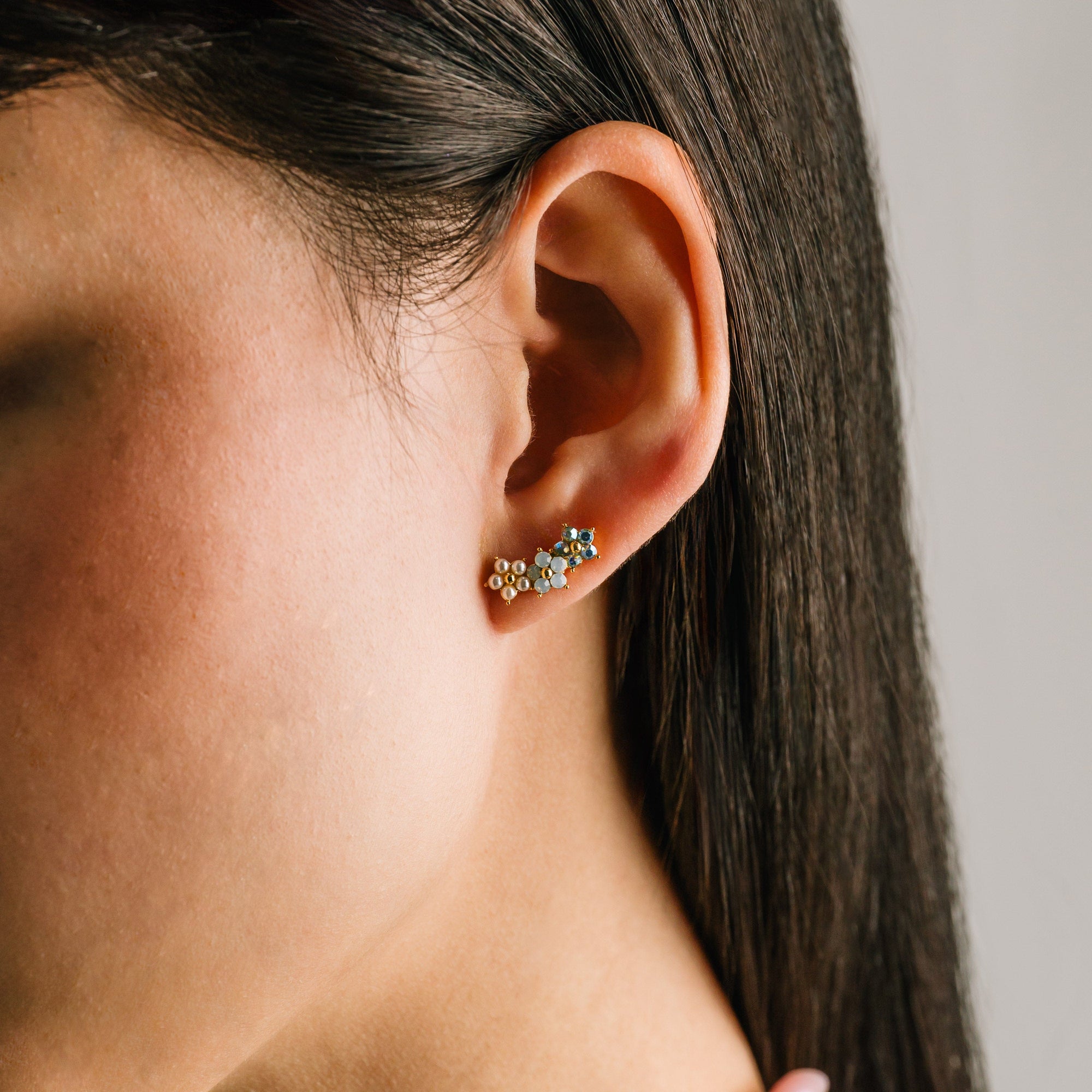 Floral climber earrings in white by Lover's Tempo, styled photo