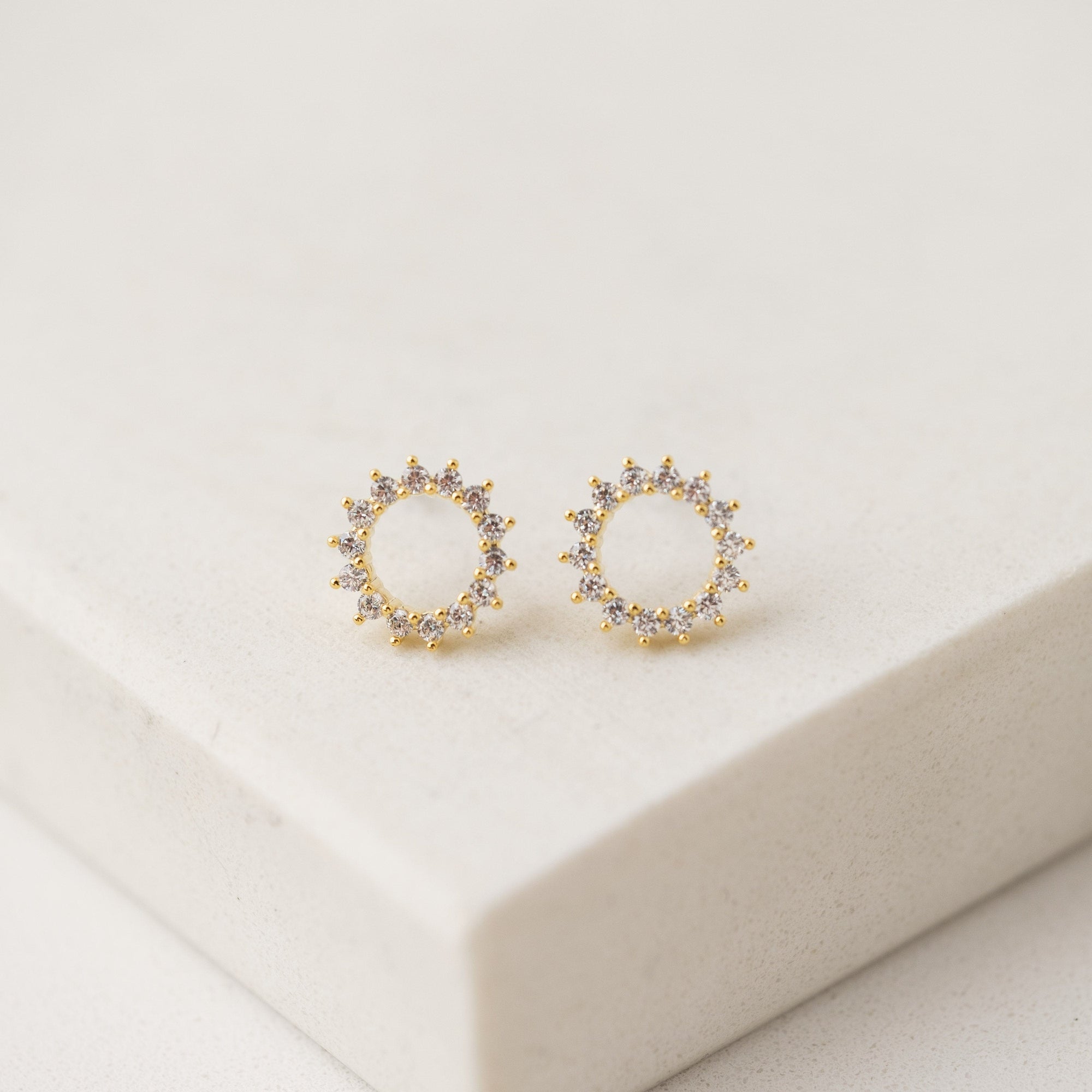 Halo stud earrings in gold by Lover's Tempo, close-up