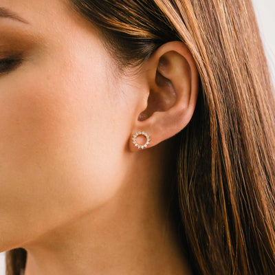 Halo stud earrings in gold by Lover's Tempo, styled photo
